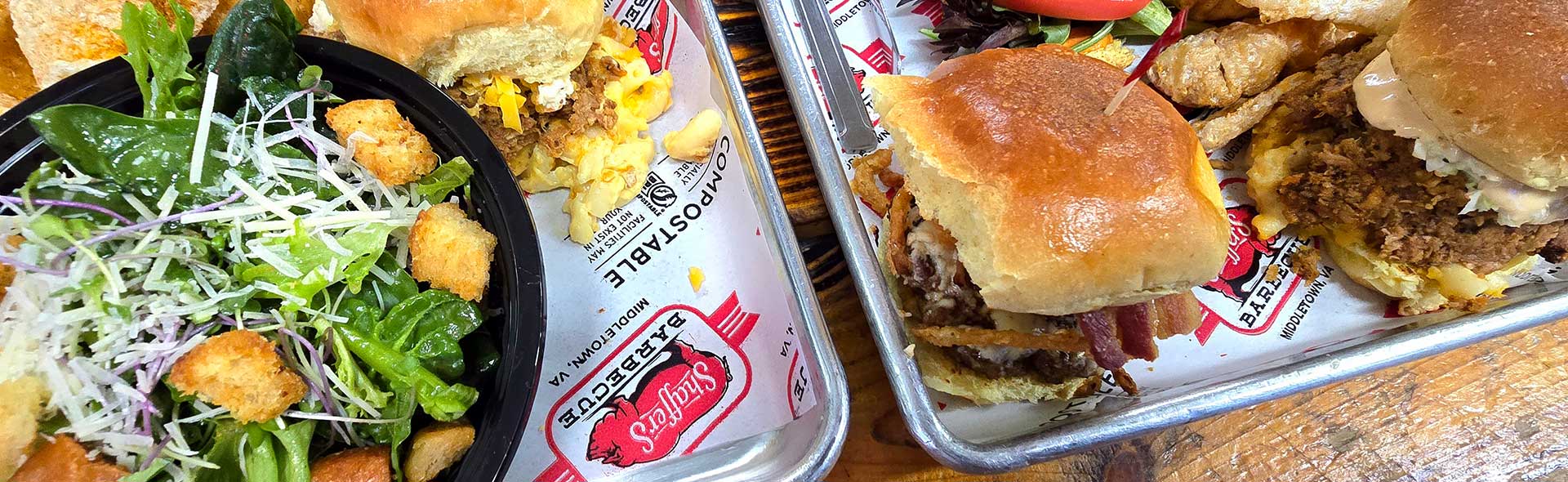 A plate of barbecue sliders from Shaffer's BBQ at a restaurant table.