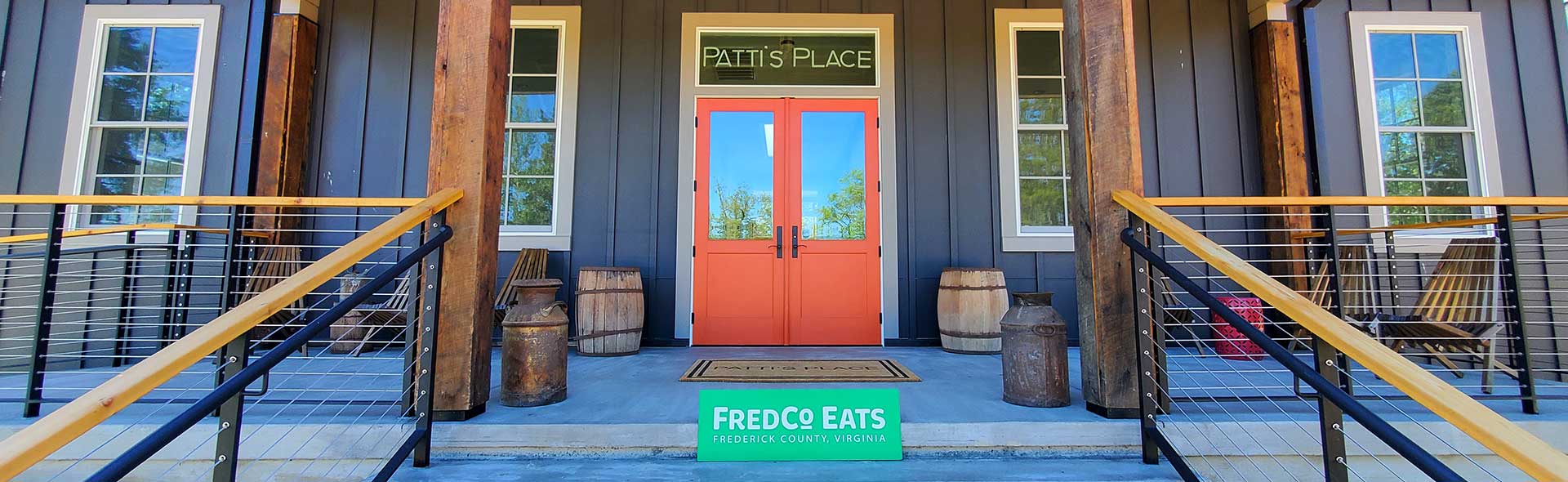 The FredCo Eats sign sits on the steps leading to the entrance to Patti's Place.
